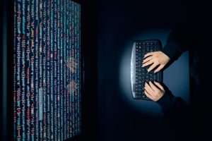 Cyber security threat. Young woman using computer to break protection. Network security threat